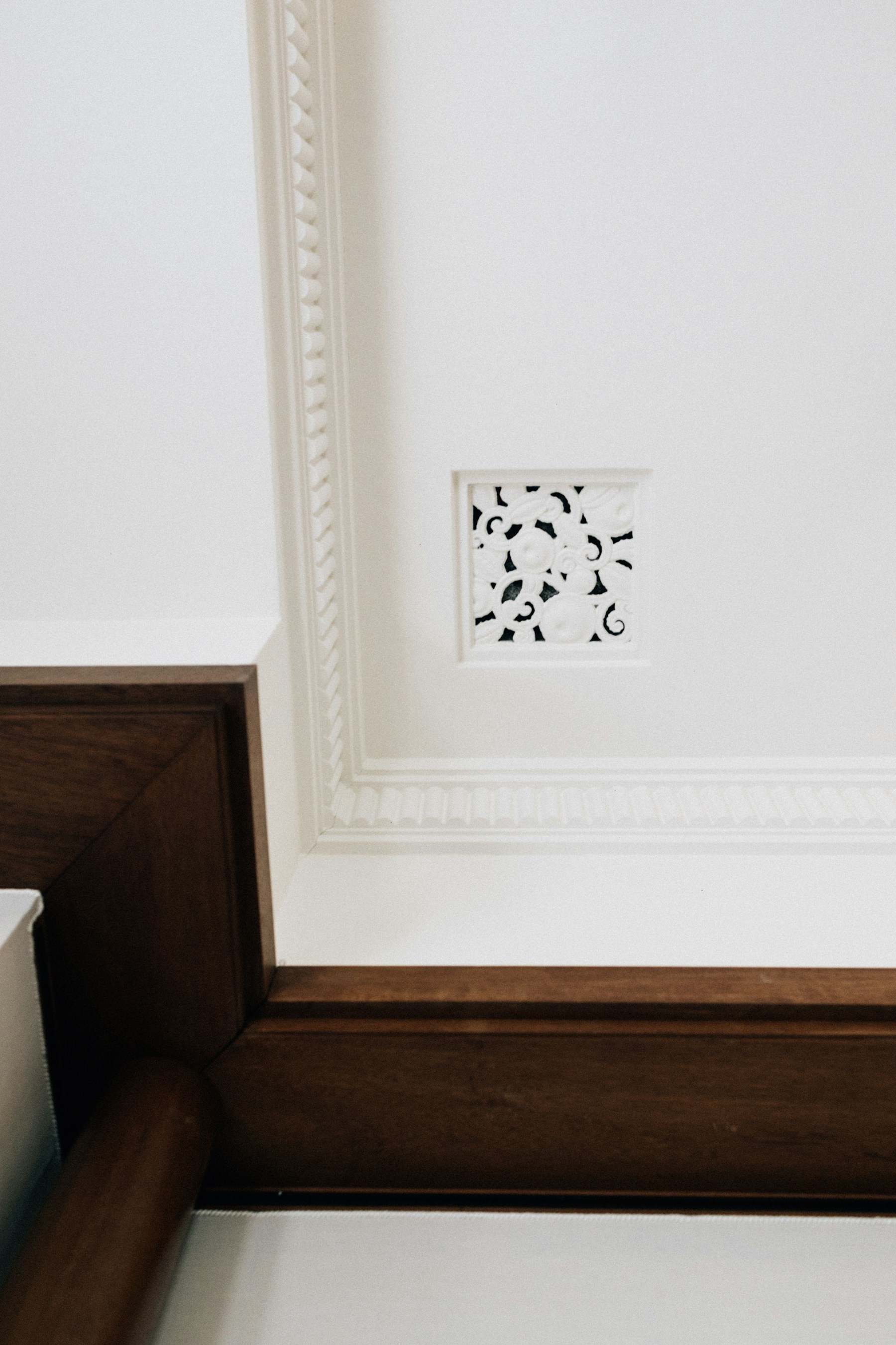 Detailed white crown molding framing a refined interior ceiling
